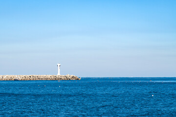seascape with a beacon on the jetty