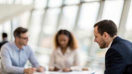 Fototapeta premium Leadership Focus Blur — Central figure in meeting subtly sharp, others blurred for vision clarity 
