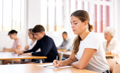 Attentive university students in advanced training courses in the auditorium