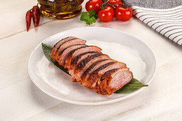 Sliced duck breast baked with cherry