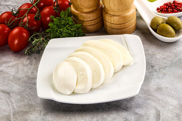 Organic mozzarella cheese slices in the plate