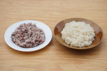 Two dish of steamed sticky rice. Different types of rice,white and riceberry grains. Nutritious Asian carbohydrate dish rich in energy and fiber. Concept rice diversity and culinary heritage of eating
