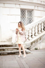 A beautiful woman with culrs hair weared business style suit, the girl is  holding a notebook and...