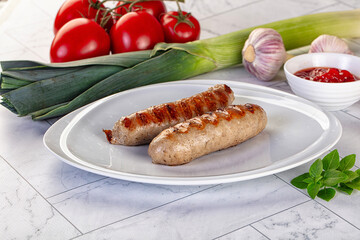 Grilled pork sausages served tomato sauce