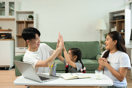 Family Asian spending happy time together on vacation, daughter homework on holiday.