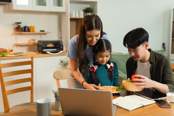 Family Asian spending happy time together on vacation, sitting in the kitchen.