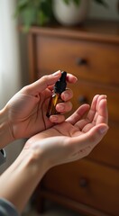 Someone holding a bottle of essential oil in their hands
