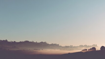 Obraz premium Sunrise Silhouette on Mountain Peaks Through Mist, Embodying Minimalist Elegance with a Clarity of Clean Sky