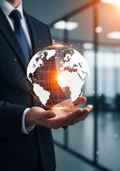 Businessman holding glowing digital globe global technology
