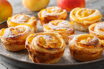 Peach Puff Pastry Roses are the perfect easy dessert  closeup on the plate on the table. Horizontal
