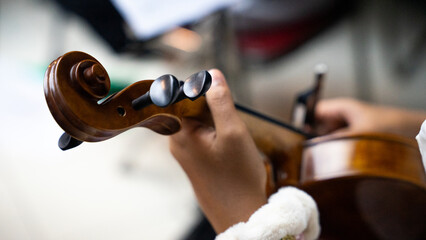 Close-Up of Violinist's Hands Playing the Violin in Orchestra Rehearsal