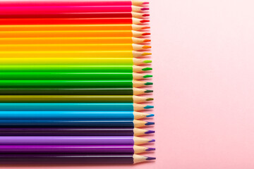 Colored pencils on a bright colored background. Equipment for coloring. Stationery for creativity.Back to school. Flatlay. Children's Creativity and Education. Rainbow.Space for text. Copy space.