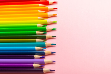 Colored pencils on a bright colored background. Equipment for coloring. Stationery for creativity.Back to school. Flatlay. Children's Creativity and Education. Rainbow.Space for text. Copy space.