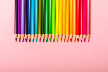 Colored pencils on a bright colored background. Equipment for coloring. Stationery for creativity.Back to school. Flatlay. Children's Creativity and Education. Rainbow.Space for text. Copy space.