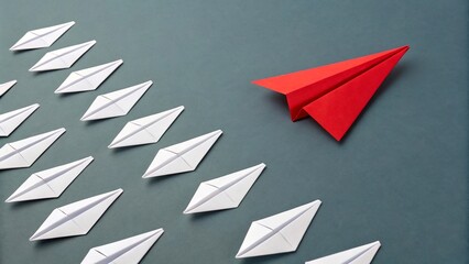 A red paper airplane leads a group of white paper airplanes, symbolizing leadership and direction on a gray background