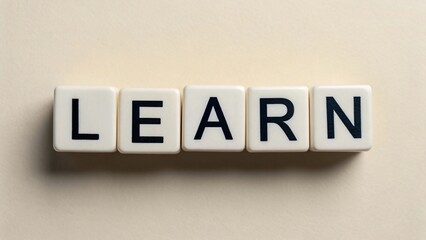 Obraz premium The word LEARN is spelled out in white blocks with black letters, representing the pursuit of knowledge and education