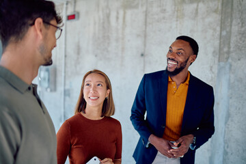 Group of multi-ethnic business partners engaging in a lively discussion about a project in a modern...