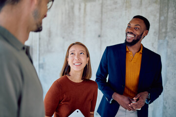 Group of multi-ethnic businesspeople engaging in lively discussions during a meeting in a modern...
