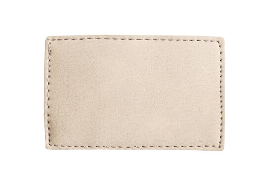 Blank leather jeans label. Beige stitched patch on white background. Empty textile tag for branding. Square fabric badge template. Clothing mockup design. Denim accessory isolated flat lay.
