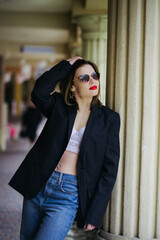 Confident woman in black blazer with lipstick