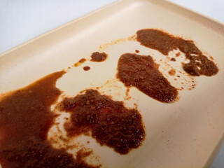 Dirty plate isolated, empty bowl after dinner, ready lunch, smeared ketchup sauce on white plate background.