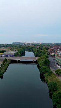 Aerial drone footage of Cardiff riverside at sunrise. Pull-out shot flying over River Taff.