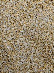 Yellow grains spread across a surface showcasing their texture and size during a natural light setting