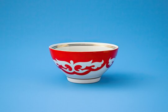 red kazakh national bowl - piala isolated on blue background. Happy Nauryz