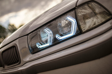 Modern led headlights shining on a sports car