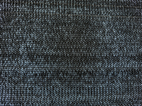 Dark knitted fabric texture creating repeating diamond pattern