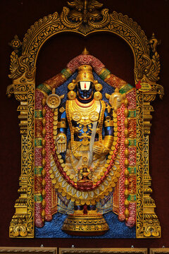 Golden statue of Lord Balaji (Venkateswara), Hindu deity in traditional ornaments, Tirupati temple, India. Hinduism, religion, spirituality concept.