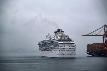 Modern Princess cruiseship cruise ship liner Coral arrival into Vancouver, Canada port on grey...