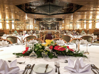 Formal and elegant ocean view dining room restaurant onboard luxury cruiseship or cruise ship liner...