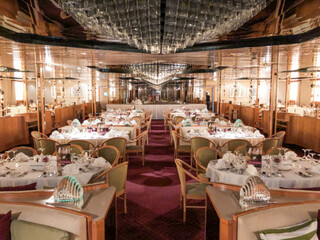 Formal and elegant ocean view dining room restaurant onboard luxury cruiseship or cruise ship liner...
