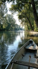 Obraz premium View from boat on peaceful river surrounded by trees and soft morning light perfect for outdoor adventure visuals, slow living concepts and eco tourism promotions