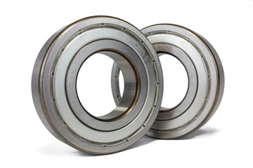 Two shiny metal ball bearings are isolated on a crisp white background.