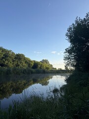Early summer morning, a guy aged 20-35 catching pike with a spinning rod