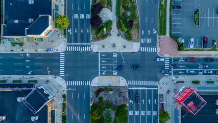 Aerial city intersection with cars and buildings.