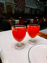 Delicious red beverages served in elegant crystal glasses at a cozy restaurant setting