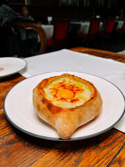 Delicious khachapuri served in a cozy restaurant during dinner time