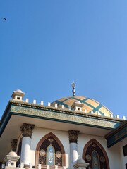 Ornate Mosque Dome with Islamic Architecture Details Under Clear Blue Sky
