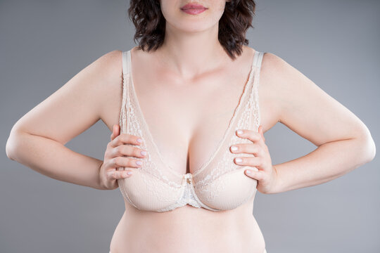 Large natural saggy breasts in a push-up bra