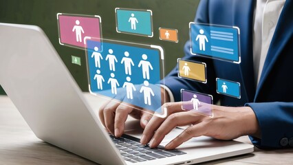 Businessman analyzing team members on digital interface while typing on laptop computer with holographic people icons