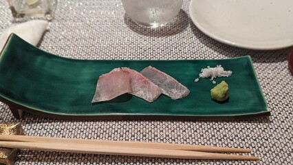 Sashimi with Salt and Wasabi on Green Plate – 緑の皿に盛られた刺身と塩、わさび