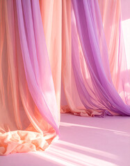 Soft and airy chiffon curtain in peach and violet gradient floating in warm naturally lit pink-toned room
