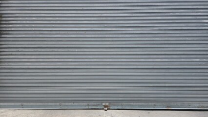 Rolling door. Steel shutter door of warehouse. The shutters are gray metal. Steel rolling shutter background. Silver metal rolling shutter background. Background images and texture images.