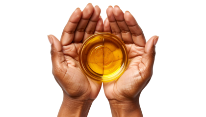 cupped hands holding a bowl of nourishing golden oil – natural skincare and wellness concept
