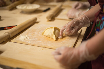 Woman cooking traditional tatarian dish Echpochmak, a baked product stuffed with potatoes, meat.