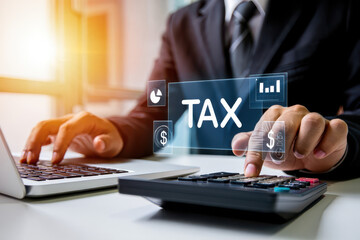 Man calculating taxes using calculator and laptop with tax graphic overlay on the screen