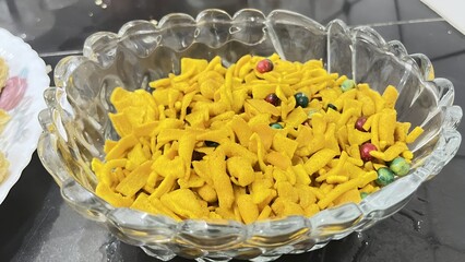 Colorful Sev Snack Mix &ndash; Spiced Indian Namkeen in Glass Bowl on Dark Background